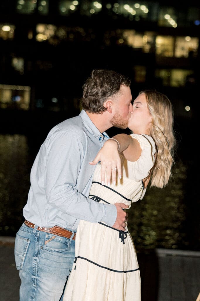 Couple sharing an intimate moment during surprise proposal at Hughes Landing in The Woodlands
