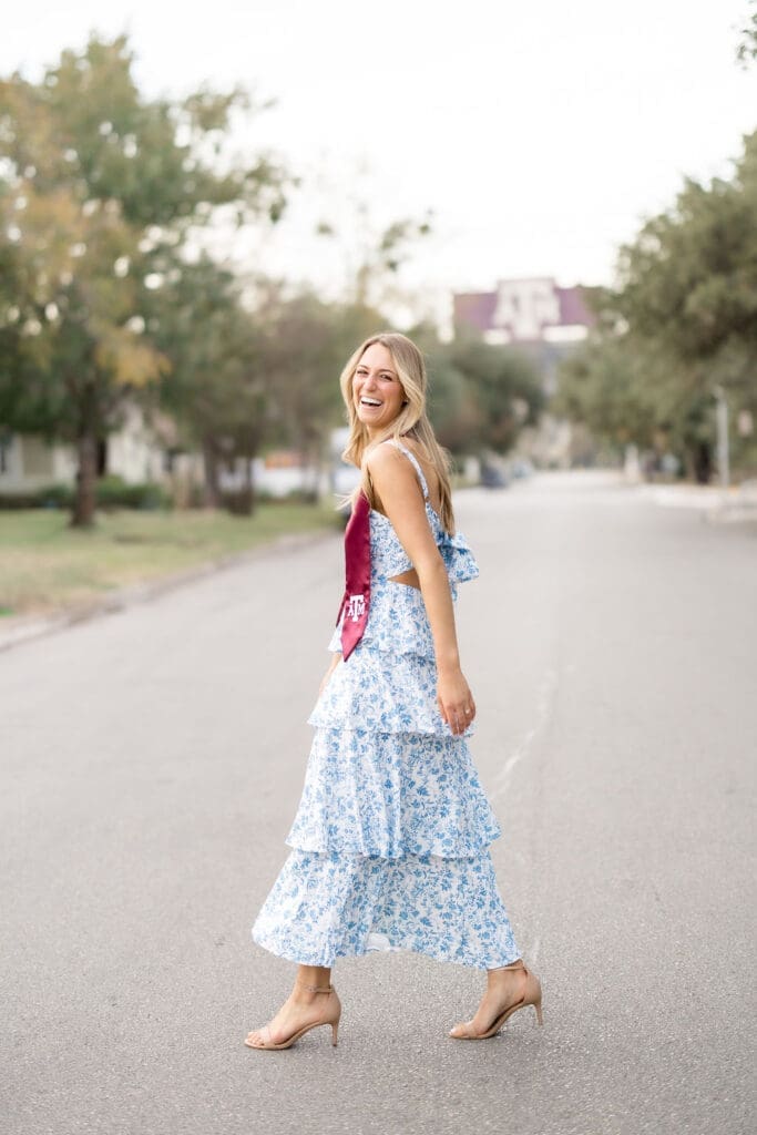Adeline’s graduation portraits with a view of Kyle Field framed by trees, adding a personal touch to her session