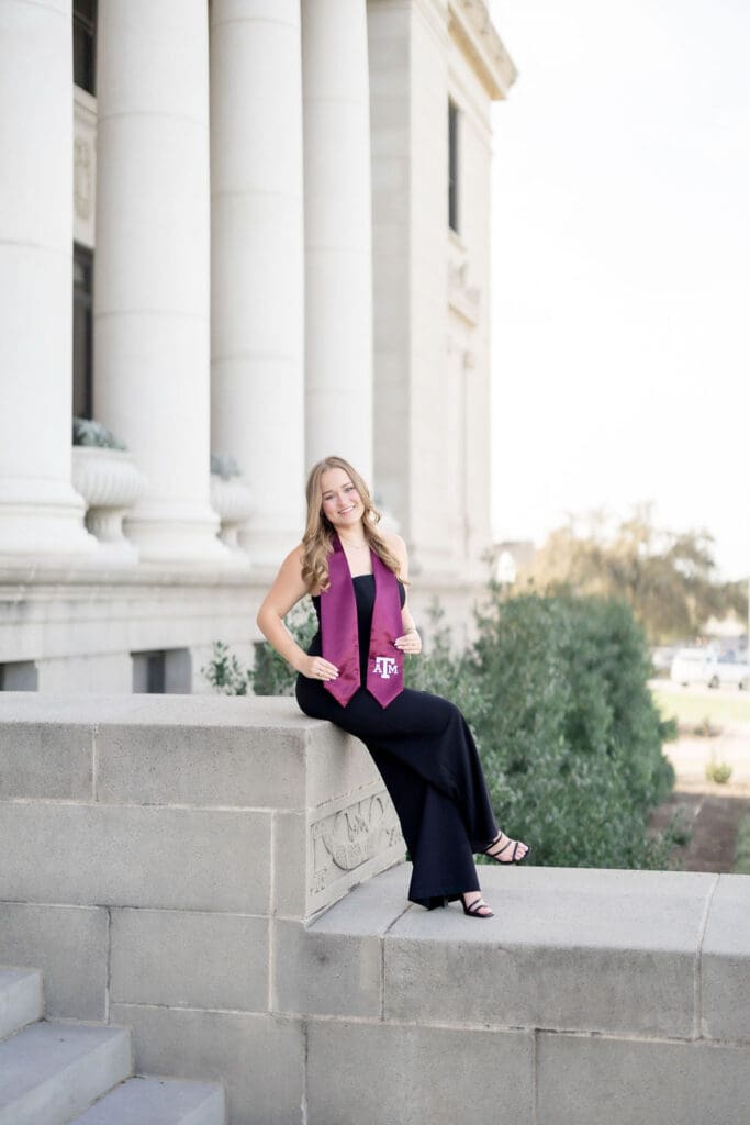 Grace posing at the Texas A&M Administration Building in her maroon stole