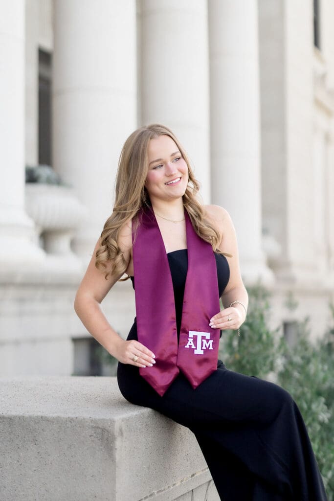Grace posing at the Texas A&M Administration Building in her maroon stole