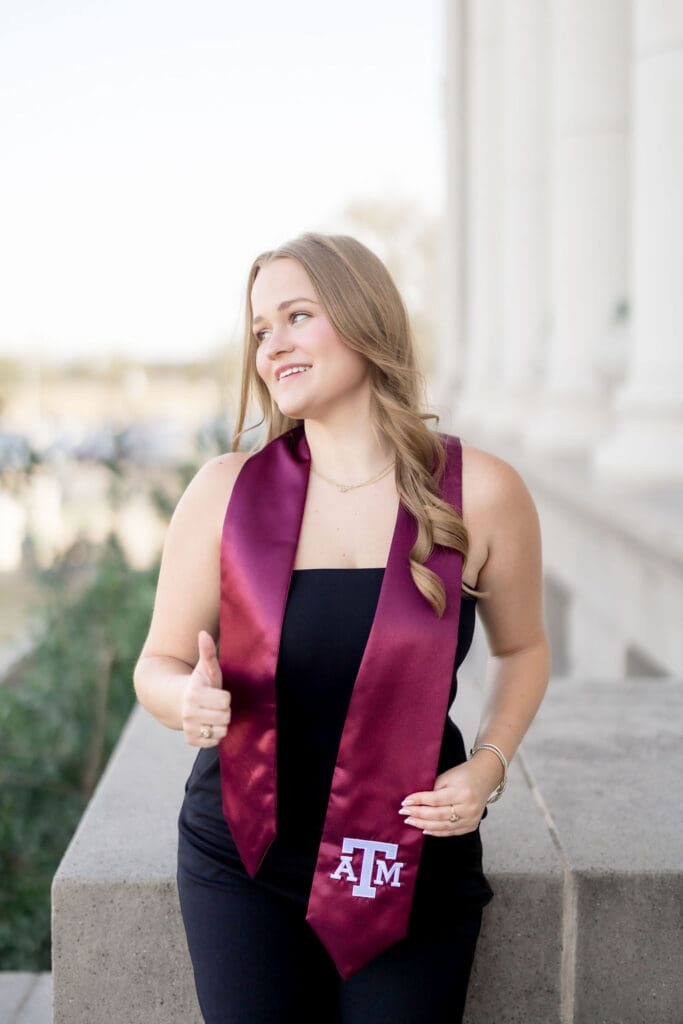 Grace posing at the Texas A&M Administration Building in her maroon stole