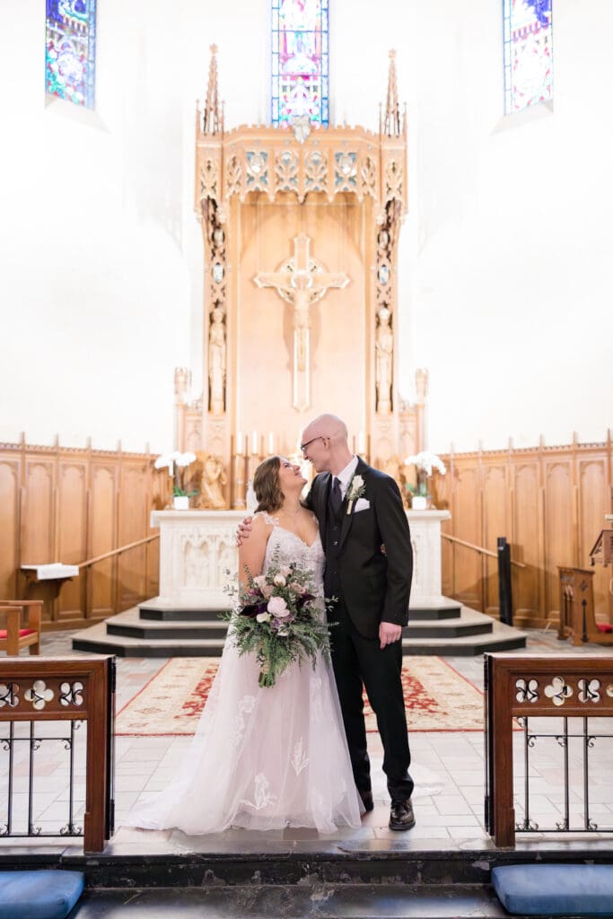 Couple exchanging vows during Catholic Mass at Holy Rosary Church in Houston, Texas