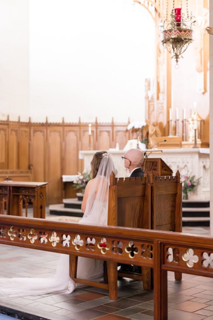 Couple exchanging vows during Catholic Mass at Holy Rosary Church in Houston, Texas