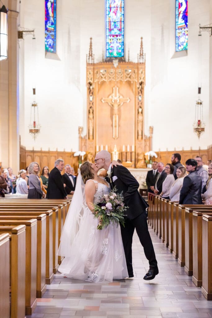 Couple exchanging vows during Catholic Mass at Holy Rosary Church in Houston, Texas