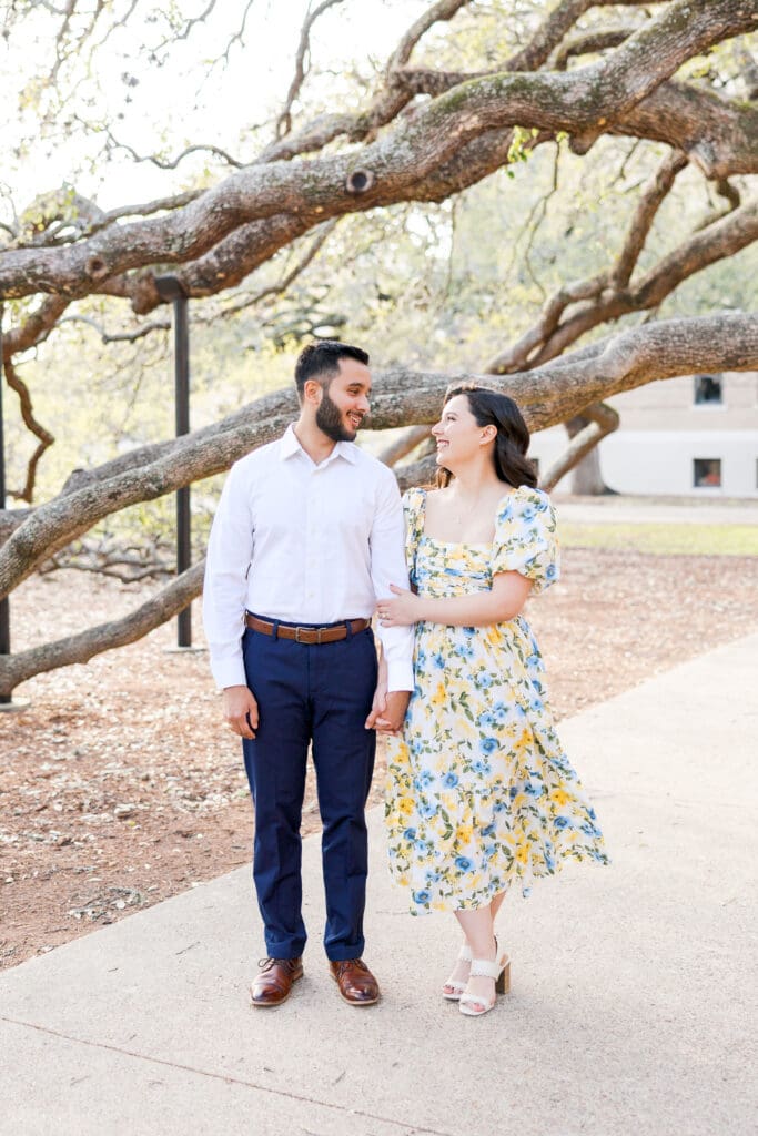 Natural light engagement portrait of couple by Texas A&M Century tree