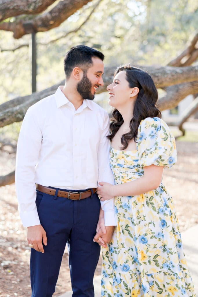Natural light engagement portrait of couple by Texas A&M Century tree