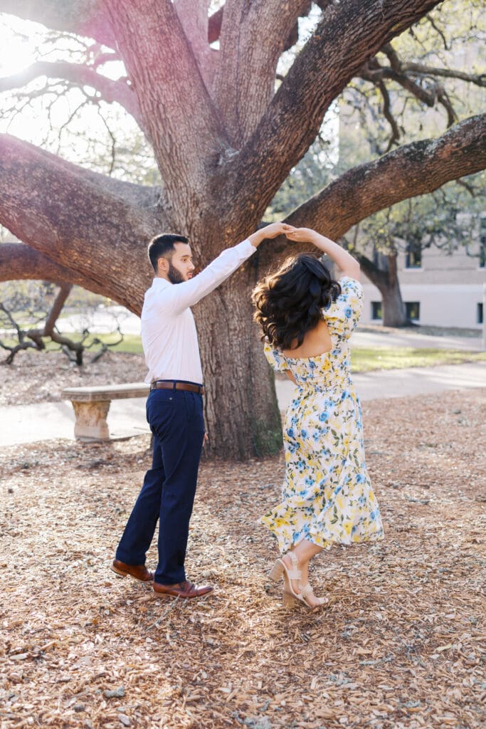 Natural light engagement portrait of couple by Texas A&M Century tree