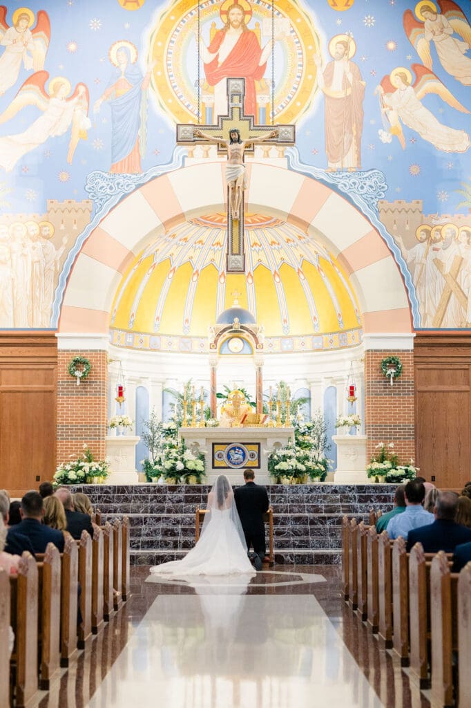 Bride and groom exchanging vows during Mass at St. Mary’s College Station