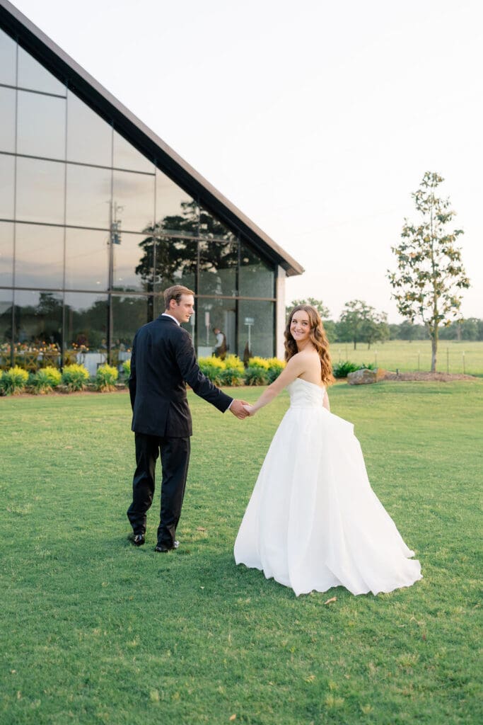 Candid reception moment at Camp Hosea captured by Catholic church wedding photographer Texas
