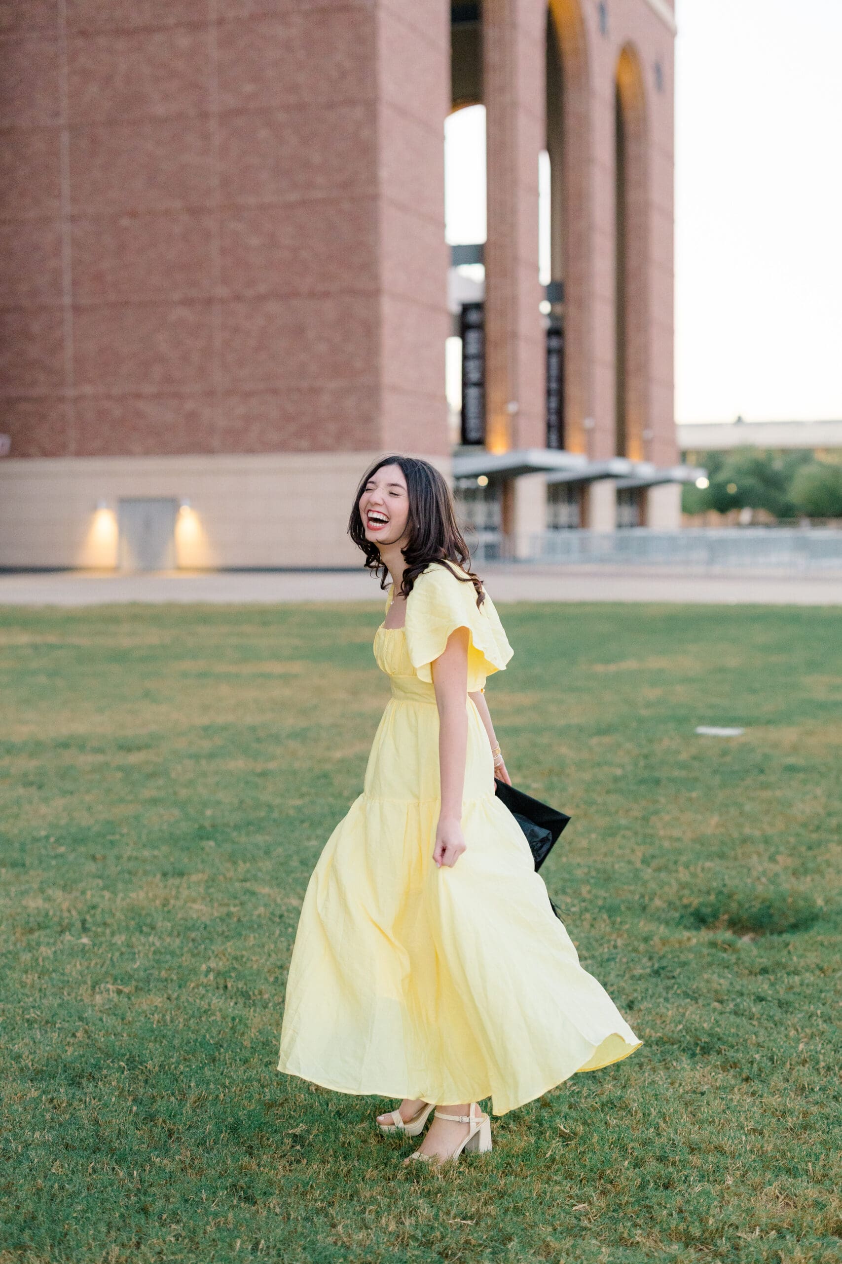 tamu senior pictures in front of kyle field and aggie park wearing yellow dress